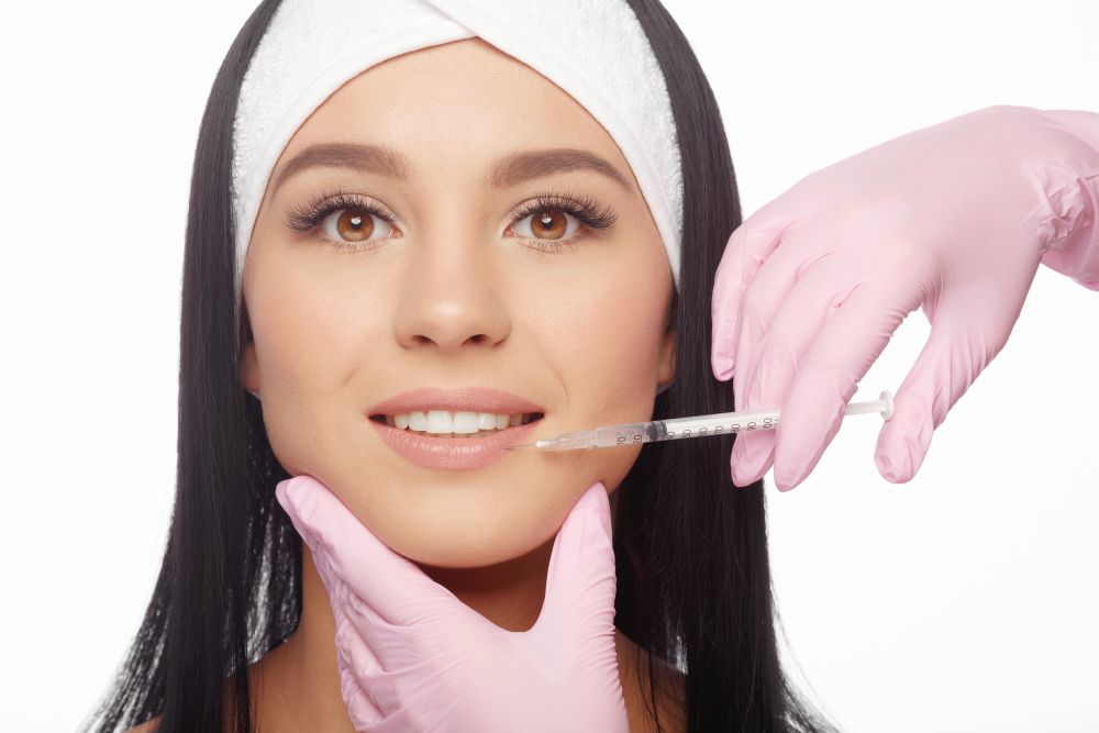 A woman getting a botox injection around her mouth